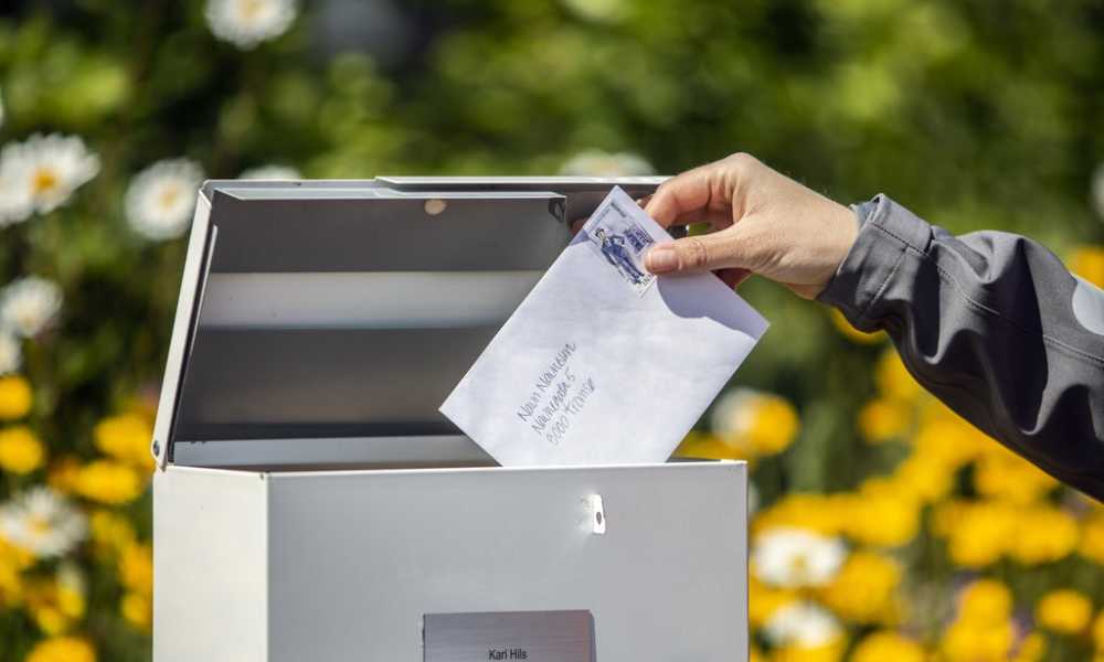 Letter with a stamp put into a mailbox