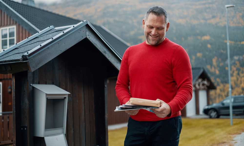 Customers picking up parcel from mailbox